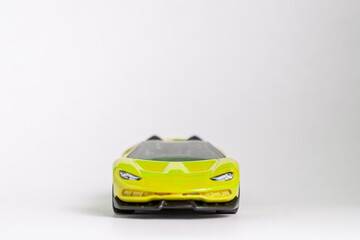 Yellow toy model convertible supercar on a white background
