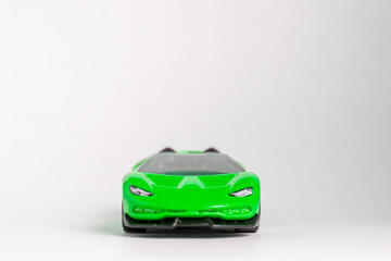 Green toy model convertible supercar on a white background