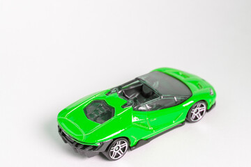 Green toy supercar on a white backround
