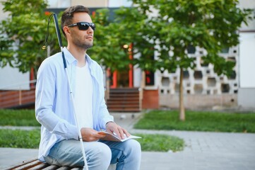 Blinded man reading by touching braille book