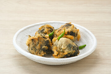 Rolade Tahu, cassava leaves with tofu crumbs fried in flour. Indonesian snack

