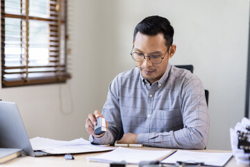 Fototapeta na wymiar Serious and focused financier accountant on paper work inside office, mature business asian man using calculator and laptop for calculating reports and summarizing accounts, 