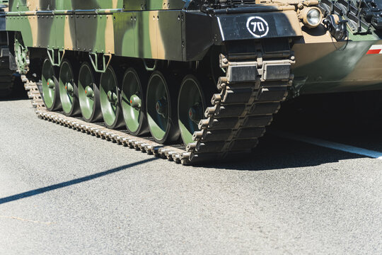 Medium outdoor shot of tank tracks. Armoured fighting vehicle equipped in tracks. Tank tracks on concrete. High quality photo