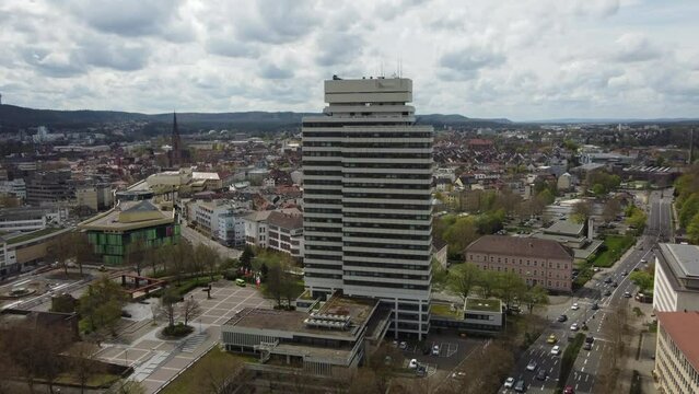 Aerial dolly in of city hall tower, shopping mall and Kaiserslautern downtown skyline cityscape, Germany.