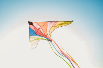 Multi colored kite flying under sky