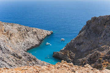 Fototapeta na wymiar one of the most beautiful beaches in Greece, nestled in a canyon leading out to the sea. Inside the narrow slip between two cliffs, Seitan Limania Crete. High quality photo