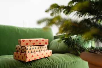 Christmas presents on green sofa at home