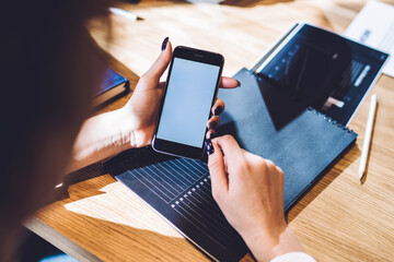 Woman surfing smartphone in office space
