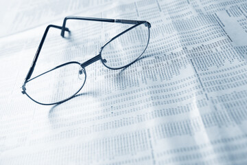 Close up of eye glasses on a business document.