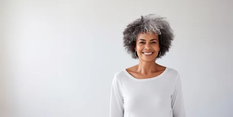 Fotobehang Portrait of smiling proud handsome african american senior woman standing against isolated white background. Wearing a white t-shirt copy space for advertisement or logo © annebel146
