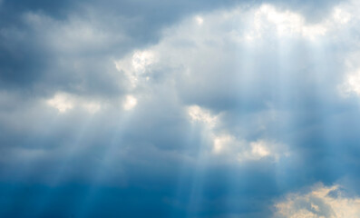 amazing blue cloudscape background with sun beams , clouds and sun rays streaming throught thr cloud