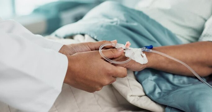 Holding hands, support and doctor with patient with iv drip in medical emergency hospital or clinic bed for medicine. Professional, healthcare and surgeon consulting person in surgery with care