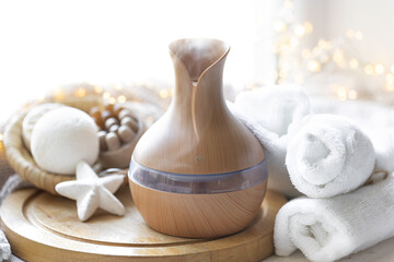 Still life with an aroma diffuser for moisturizing the air and winter decor.