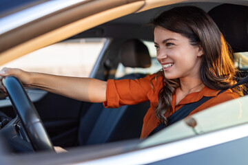 Happy business woman traveling with her car around the city. Beautiful young happy smiling woman...