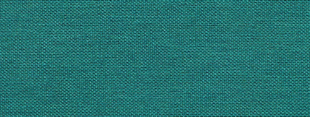 Poster Dark emerald background from a textile material with wicker pattern, closeup. Vintage cyan fabric with texture. © nikol85