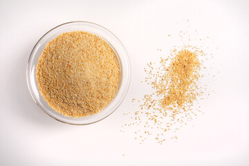 breadcrumbs in glass bowl on white background shot from above