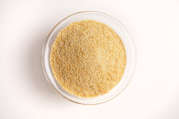 breadcrumbs in glass bowl on white background shot from above