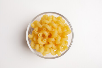 macaroni inside a glass bowl on a white background seen from above