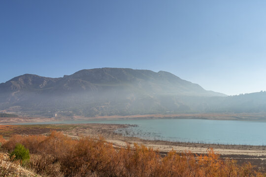 Foggy haze above the Negratin lake in Andalusia, Spain, on a sunny winter day