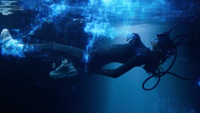 Beautiful woman with flowing hair in futuristic dress under the water. Girl in glasses of virtual reality. Augmented reality, game, future technology concept. VR.