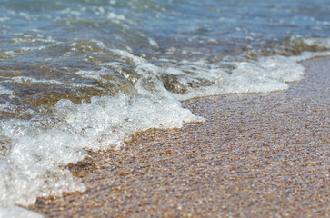 Soft wave of sea on sandy beach. Background.