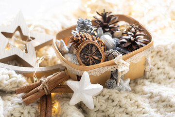 Cozy winter still life, Christmas decorations on cozy blanket.