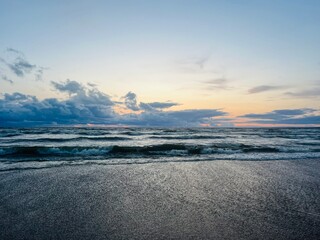 Fototapeta premium Cloudy seascape, sea shoreline, sunset time