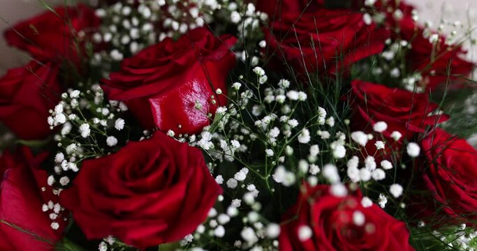 Beautiful red roses in bride bouquet closeup 4k movie. Floristry concept