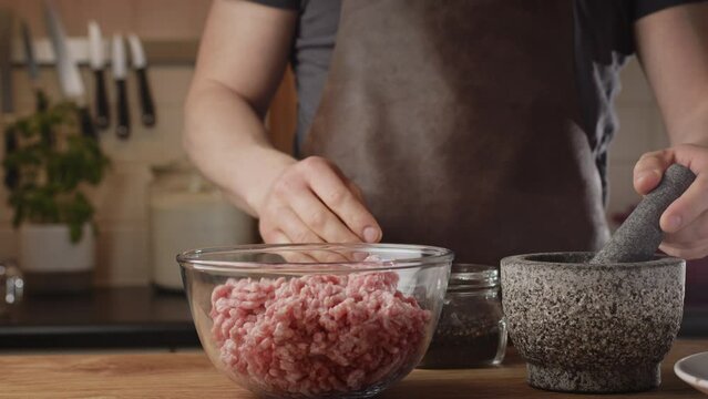 Home chef preparing a BBQ recipe - the Balkan kebapche or cevapcici. Closeup shot. Low angle.