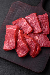 Fresh juicy raw beef slices with salt and spices