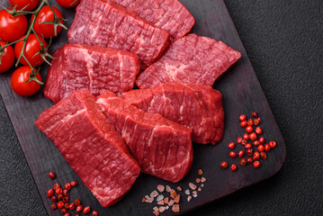 Fresh juicy raw beef slices with salt and spices