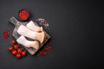 Pleurotus eryngii mushrooms on a dark concrete background