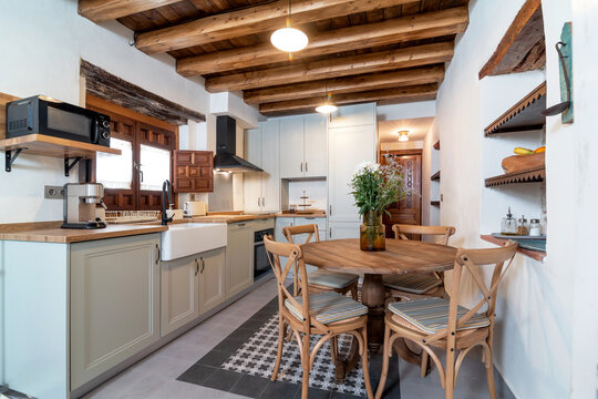 Bright kitchen and dining room interior in contemporary rustic apartment