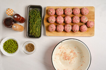 Top view of raw meatballs on a kitchen table