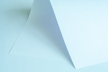 A large piece of paper in cool colors as a background. Grainy image.