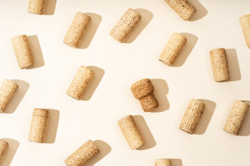 Pattern with wine and champagne corks, sun glare from a champagne bottle on a beige background with...