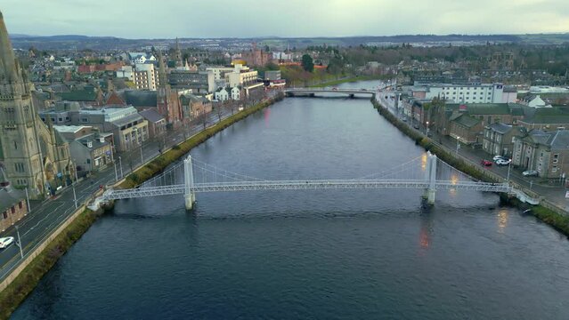 flying above the Ness river towards the Greig street Bridge as pedestrians cross