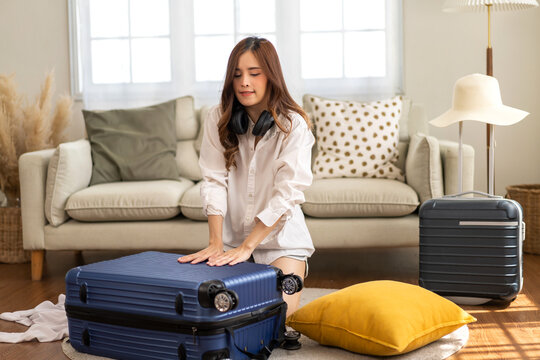 Portrait of backpacker beauty asian traveler woman packing prepare stuff and outfit clothes in suitcases travel bag luggage for summer, holiday, weekend, tourist, journey, vacation trip at home.travel