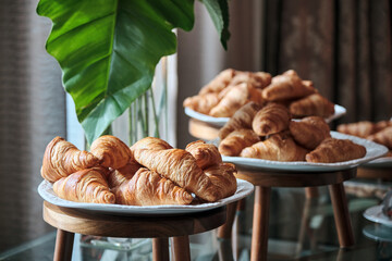 many croissants in many trays awaited to be served to the business conference attendees during the...
