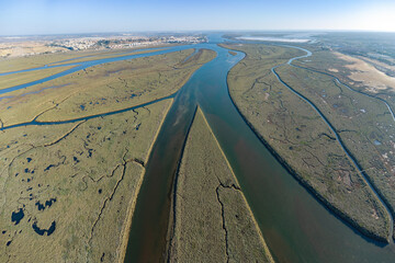 Aerial wide angle view of the river Odiel mouth at sunset. Estuary of Rio Odiel in the marshes...