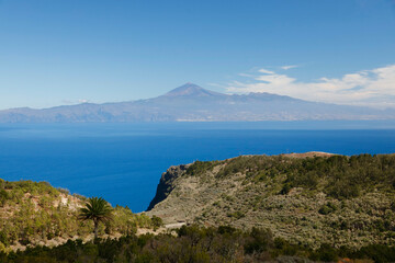 Fototapeta na wymiar La Gomera, Spain. View of Teide volcano from the plateau above the Gomeran village of Agulo. 
