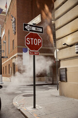 steam near road signs and vintage buildings in downtown of new york city, metropolis atmosphere