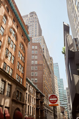 Fototapeta premium do not enter sign on avenue with modern and vintage buildings in new york city, urban streetscape