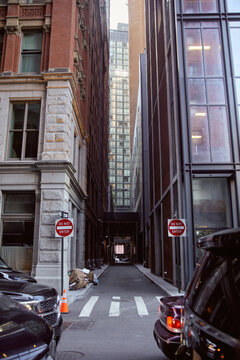 cars parked near do not enter road signs between modern buildings on urban street in new york city © LIGHTFIELD STUDIOS