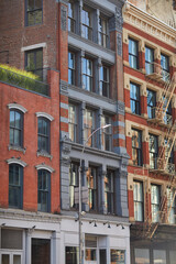 Obraz premium vintage buildings with fire escape stairs in downtown of new york city, streetscape in autumn