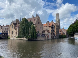 Obraz premium traditional bruges houses and canals with flowers and boats, netherlands amsterdam, dutch houses