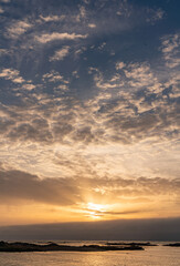 Fototapeta na wymiar Sunset over the ocean at Rhosneigr, Isle of Anglesey