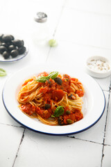 Traditional pasta with tomatoes, olives and anchovy