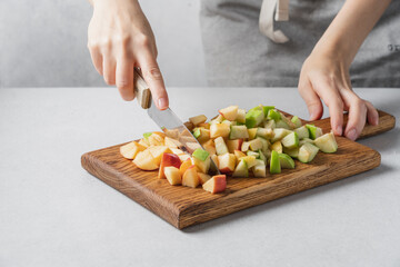 Female hands cutting fresh apples. Cooking food concept