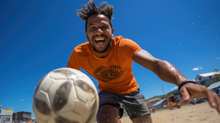 Portrait of happy brazilian man playing football on beach.